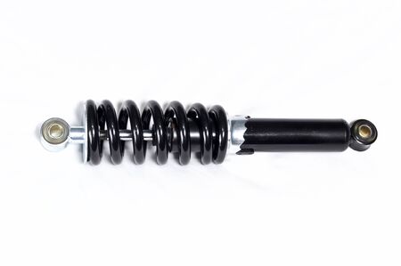 a brand new clean black and silver motorcycle shock absorber over white, this shock is also used on ATVs.の写真素材
