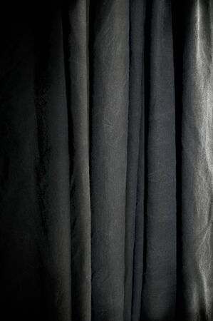 vertical overlapping folds of black photography studio background cloth.の写真素材