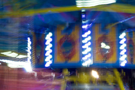Colorful vibrant image of streaking lights of carousel  merry go round. Natural motion blur with long exposure.の写真素材