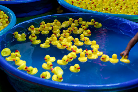 Numerous kiddie pools full of rubber ducks at carnival or amusement park.の写真素材