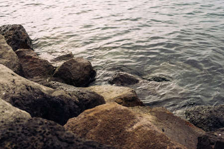Stones on a shore and ocean in reykjavik icelandの写真素材