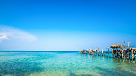 Old wooden pier in Clear water and beautiful bay on Samet Island, Rayong, Thailand.の写真素材