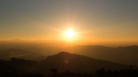 Orange light of the Sunset Over Mountains, Phu Chi Fa, Chiang Rai, Thailand.の写真素材