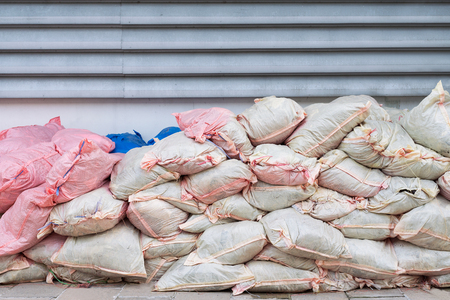 Piles of Waste Sacks White and Pink Placed by the Wall.の写真素材