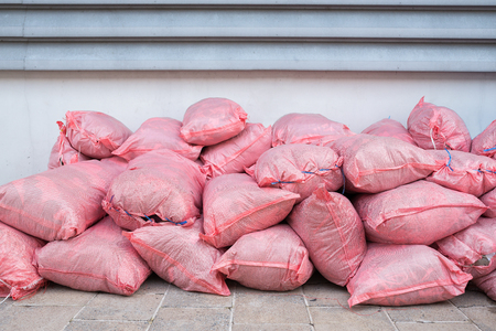 Piles of Waste Sacks Pink Placed by the Wall.の写真素材