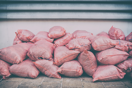 Piles of Waste Sacks Pink Placed by the Wall.の写真素材