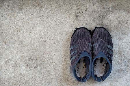 Old Shoes on the concrete floor.の写真素材