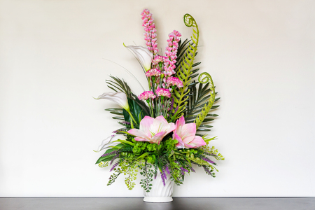 Bouquet in a white jar on wooden table.の写真素材