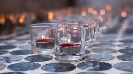 Candle in a glass on floor.の写真素材