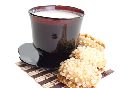 Cup of milk on a black saucer with tasty cookies.  Easy breakfastの写真素材