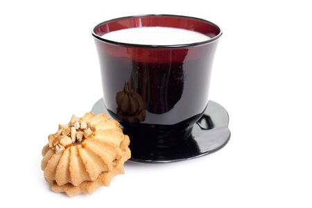 Cup of milk on a black saucer with tasty cookies.  Easy breakfast.の写真素材