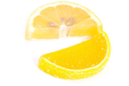 Fruit jellies. Jelly candies and fresh citrus in form lobules isolated on a white backgroundの写真素材