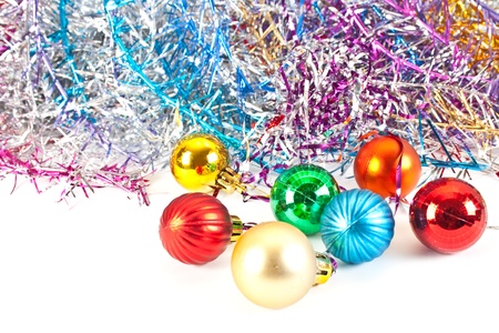 Christmas and new-year decorations. Christmas balls and varicoloured tinsel isolated on white background の写真素材