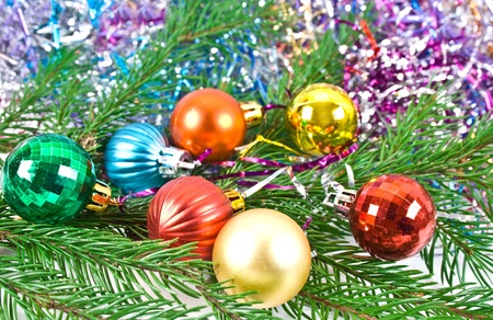 Christmas and new-year decorations. Fir tree branch with decoration on a tinsel background. の写真素材