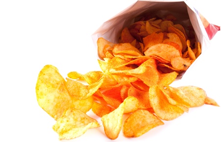 Bag of fried Potato Chips. Potato chips poured out from packing on a white backgroundの写真素材