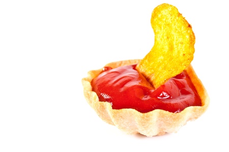 Potato chips and tomato ketchup on a white backgroundの写真素材
