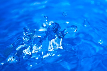 Water splash. Abstract background from hardening water on a dark blue backgroundの写真素材