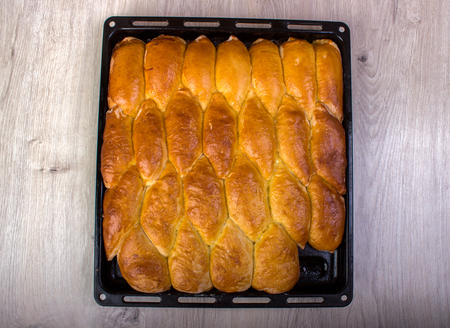 Oven fresh home made baked patties. Delicious pastries on a baking sheet. Russian pirozhki baked patties . Traditional russian pies, good food for holidayの写真素材