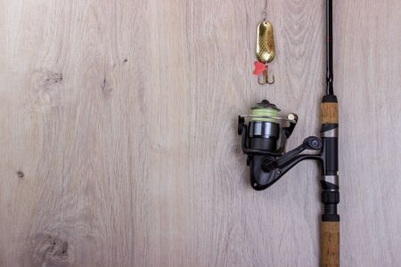 Spinning, baubles on a wooden background. Fishing equipmentの写真素材