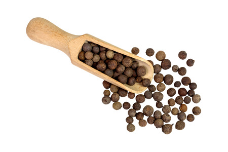 allspice in a wooden bowl. Black pepper. Spice. isolated on white background.の写真素材
