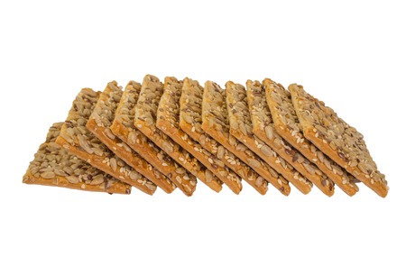 crispy bread with seeds of sunflower, flax and sesame seeds Isolated on white backgroundの写真素材
