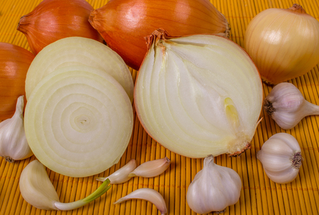 Garlic and onion, pepper on wooden board.の写真素材