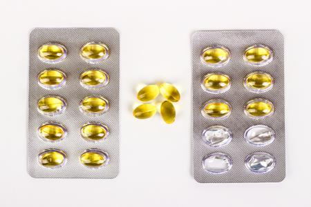 Fish oil capsules on white background. Health care concept.