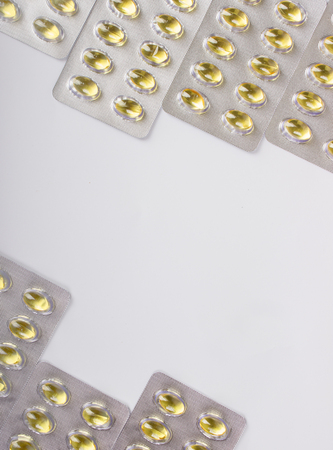 Fish oil capsule isolated on white, health care and medical conceptの写真素材