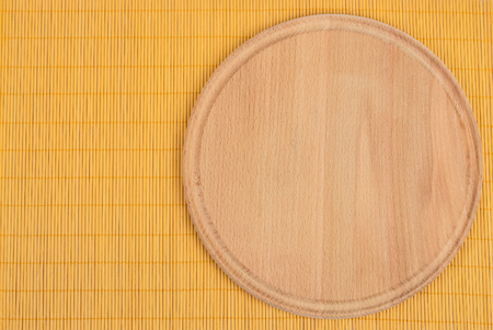 Background for product montage. Empty round wooden board with tablecloth.の写真素材