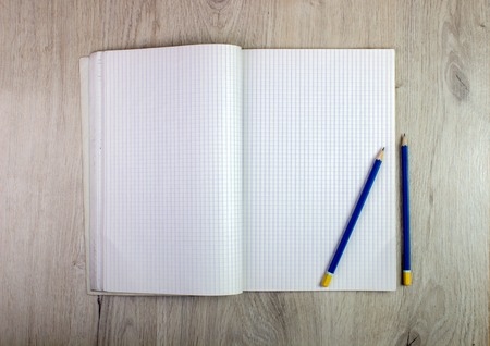 Blank empty notepad and pencil on wood tableの写真素材