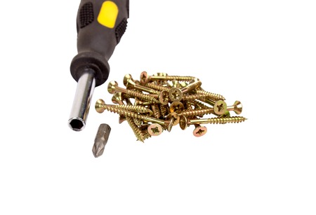 Screws and screwdriver isolated on white background.