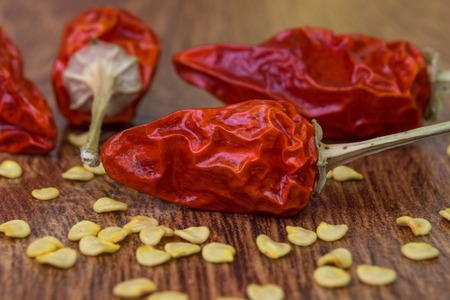 Dried, small red chili pepper on the background of wood, close-upの写真素材