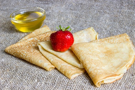 Delicious pancakes on Sacking with strawberries and honey.の写真素材