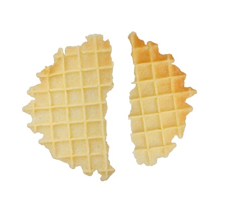 Broken round waffles isolated on white background.の写真素材