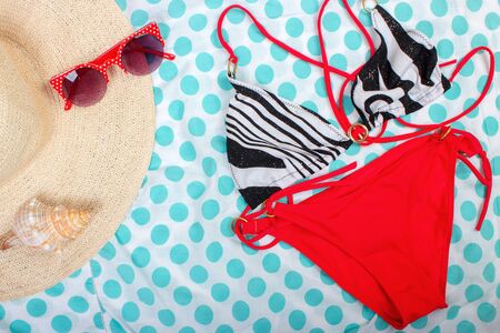 Straw Beach Woman's Hat Sun Glasses Top View Seashell Women's swimsuit with space for text.の写真素材