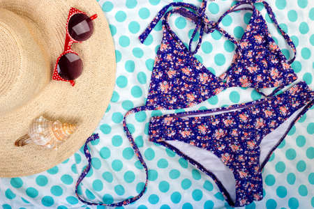 Straw Beach Woman's Hat Sun Glasses Top View Seashell Women's swimsuit with space for text.の写真素材