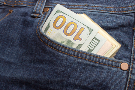 American dollar bills in jeans pocket backgroundの写真素材