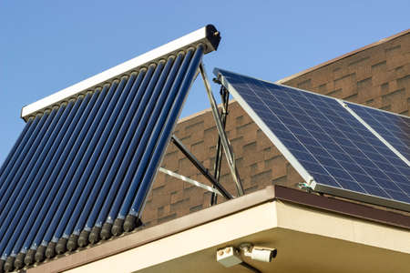 Domestic solar panel on a roof, with clear, cloudless sky
