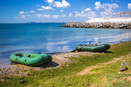 Rubber boat on the sea shore. Rubber inflatable boat for fishing