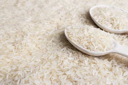 close up of white rice cereal and wooden spoonの写真素材