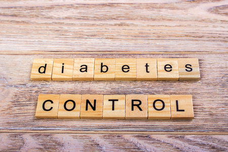 word diabetes on wooden cubes. Control diabetes. On a wooden tableの写真素材