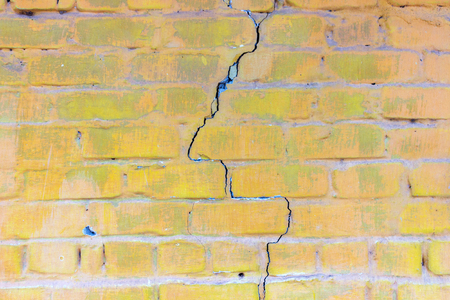 Background of old vintage dirty brick wall with peeling plaster. Background or texture.の写真素材