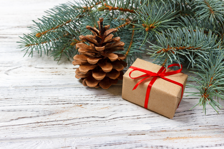 Christmas or New Year presents wrapped in natural colored paper and decorated with traditional Xmas twine and fir twigs on white background.の写真素材
