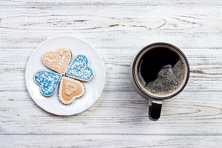 Cup of coffee and cookies on rustic wooden table.の写真素材