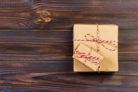 Christmas presents laid on a wooden table background.