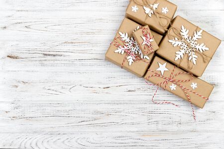 Christmas wooden background with gift boxes and decor. Top view with copy space for your text.