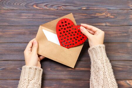 girl holding an envelope with valentine hearts. Valentine day concept with copyspace.の写真素材