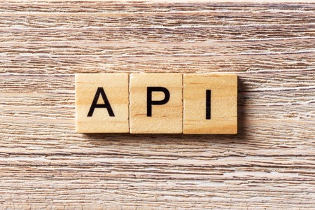 API word written on wood block. application program interface text on table, concept.