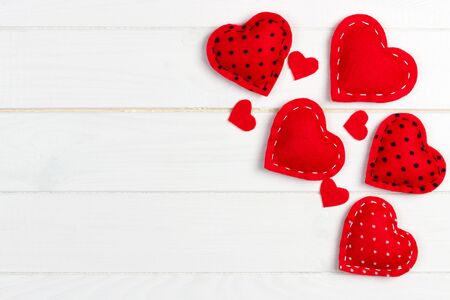 Valentines day background with handmade toy hearts on wooden table.の写真素材