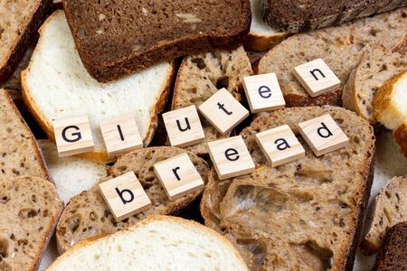 Gluten bread text. Sliced bread on the top of table, gluten free concept. Homemade gluten free bread for people with allergy.の写真素材
